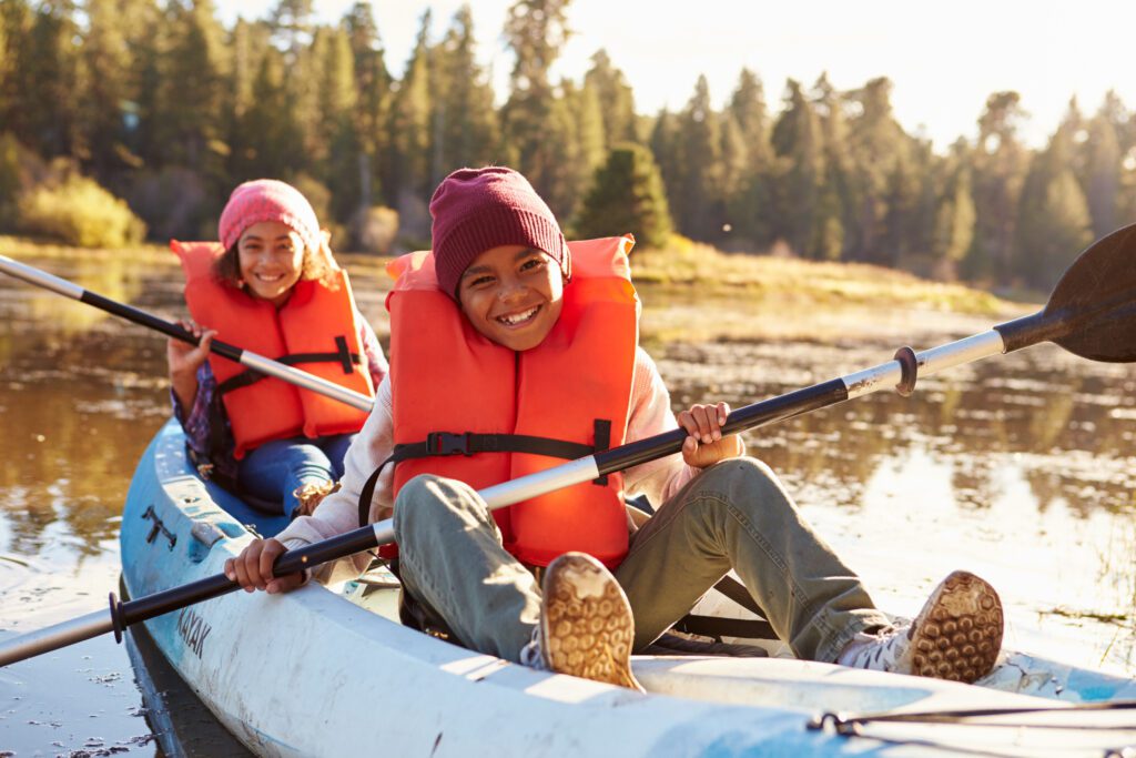 Kids kayaking on a lake.